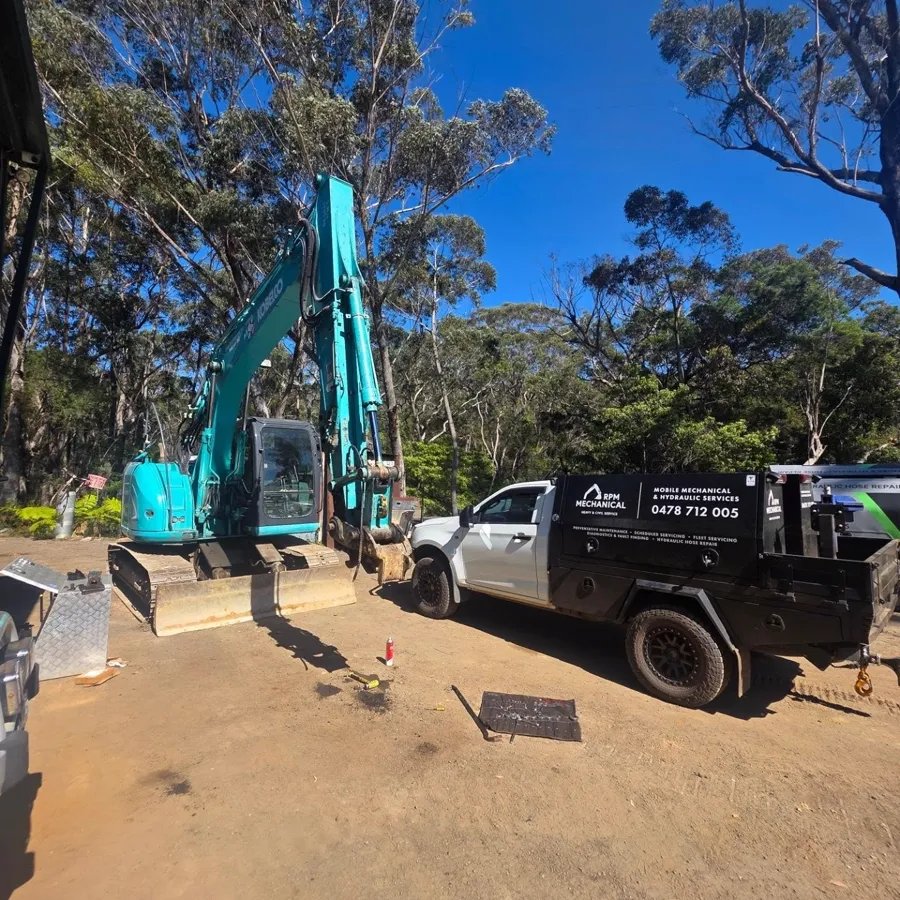 RPM service ute beside a Kobelco excavator on a bush worksite