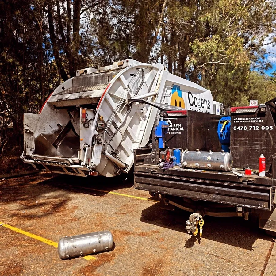 RPM service ute set up behind a compactor truck